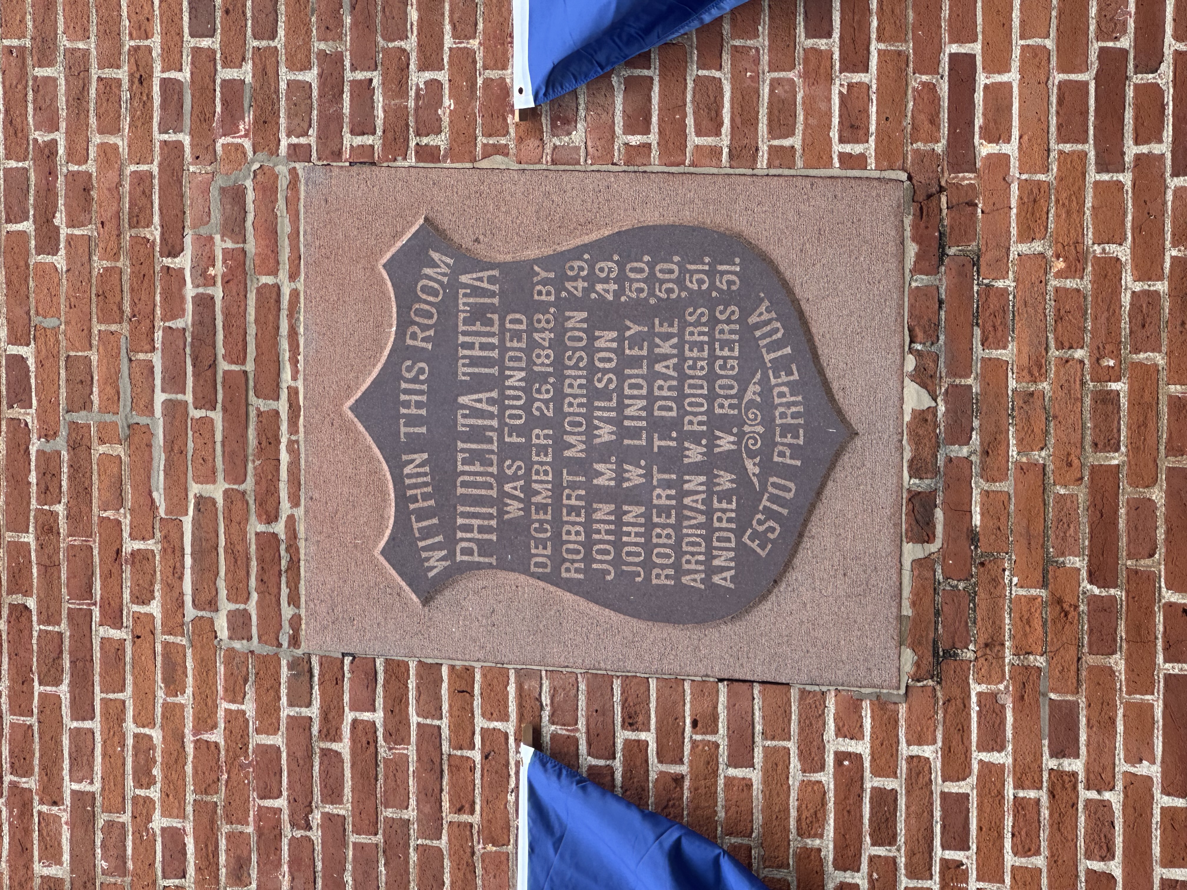 A plaque outside of Elliot Hall commemorating the founders of the fraternity