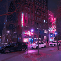 A street at night with bright neon signs